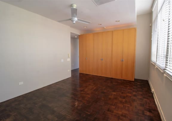 a bedroom with a closet and a window with blinds at Metro67, Memphis, Tennessee