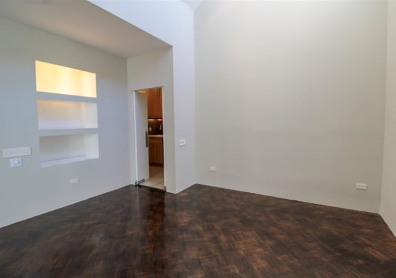an empty living room with white walls and wood flooring at Metro67, Memphis, Tennessee, 38103