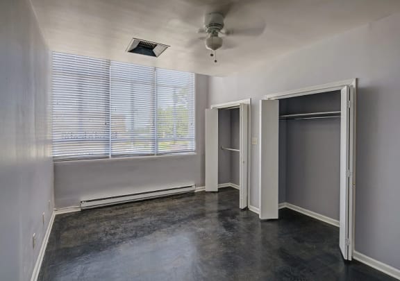 an empty room with a large window and a ceiling fan at Metro67, Memphis, TN