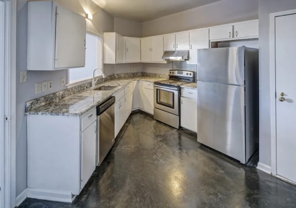 a kitchen with a large island with granite countertops at Metro67, Memphis, TN, 38103