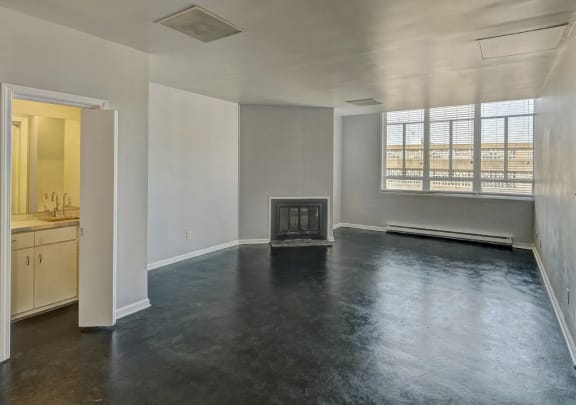 an empty living room with a fireplace and a window  at Metro67, Memphis, TN, 38103