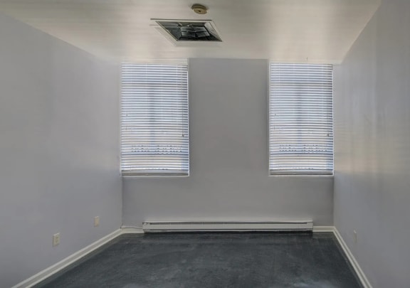 an empty room with three windows and a carpet  at Metro67, Memphis, TN, 38103