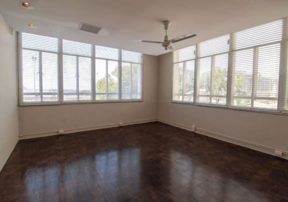 an empty living room with wood floors and a ceiling fan at Metro67, Memphis, TN