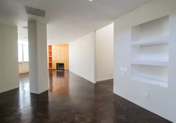 an empty living room with white walls and wood floors at Metro67, Memphis, Tennessee, 38103