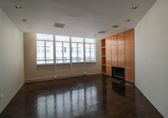 an empty living room with a fireplace and a large window at Metro67, Memphis, Tennessee