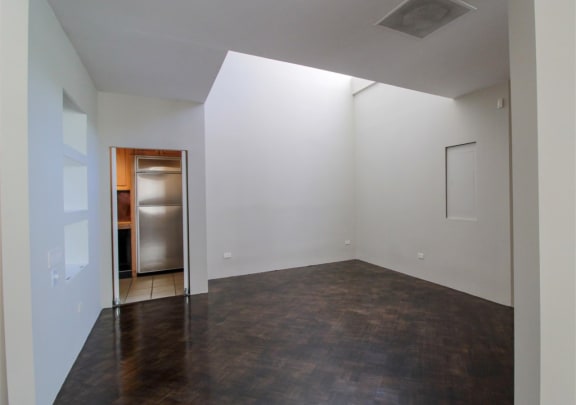 an empty living room with white walls and a door to a kitchen at Metro67, Memphis, TN, 38103