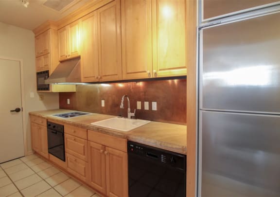a kitchen with wooden cabinets and stainless steel appliances at Metro67, Memphis, Tennessee
