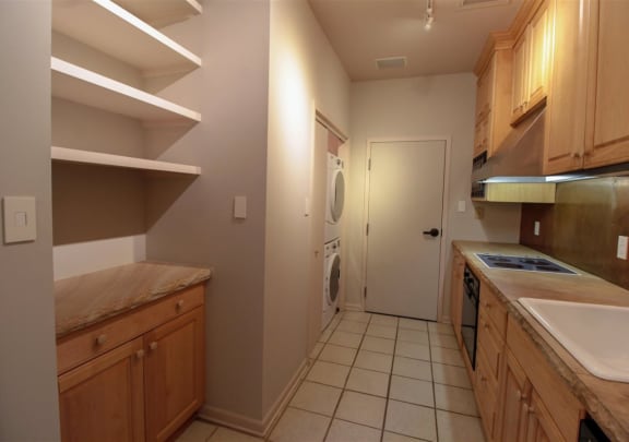 a kitchen with a washer and dryer and a door to a laundry room at Metro67, Memphis, TN