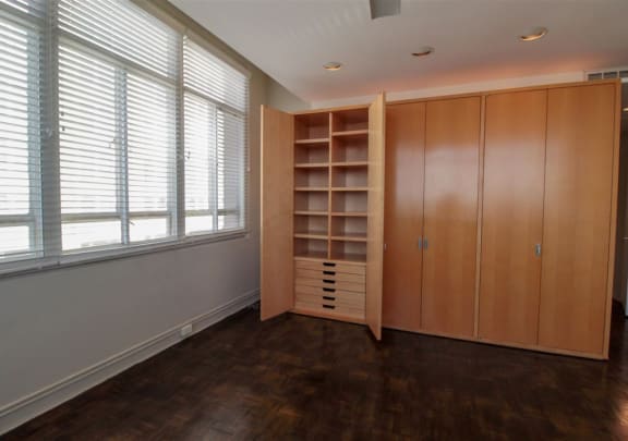 a bedroom with a closet and a window with blinds at Metro67, Memphis, 38103