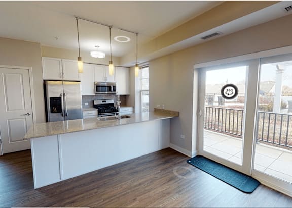 A kitchen with a white counter and a microwave on it.