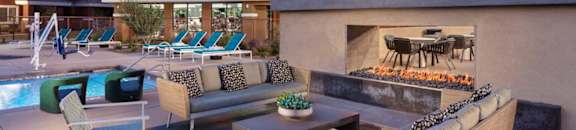 a patio with couches and chairs and a fire place at Zaterra Luxury Apartments, Chandler, AZ