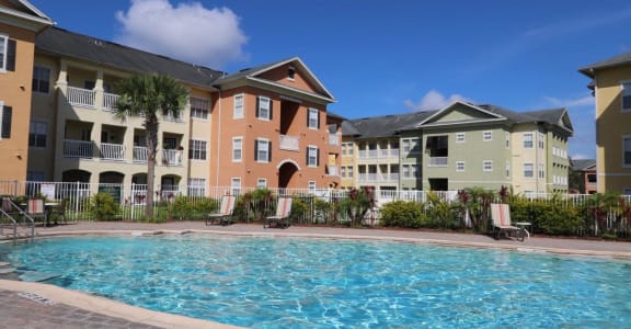 an apartment building with a swimming pool in front of it