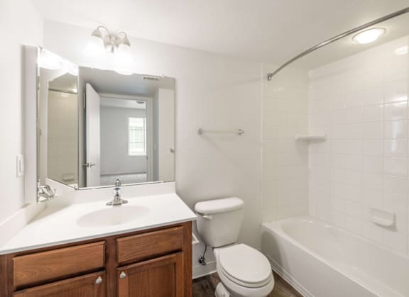 white bathroom with wood vanity
