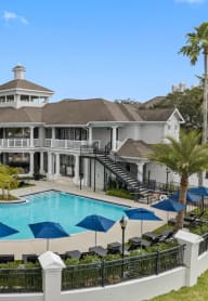 a large swimming pool in front of a large house