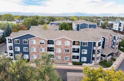 an aerial view of a building with blue and red apartments