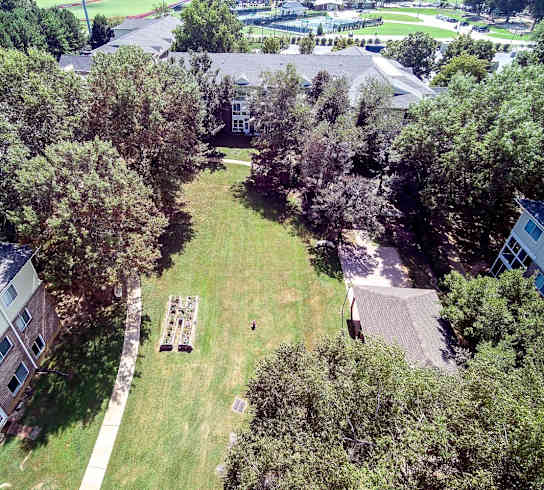 an aerial view of a yard with houses and trees