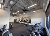 Thumbnail 1 of 11 - a gym with treadmills and other exercise equipment
