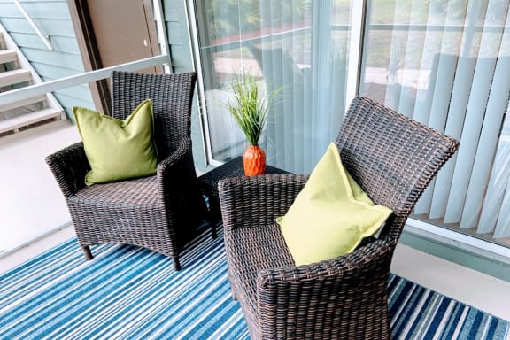 Patio with Comfortable Chairs at Lake in the Woods in Melbourne, FL