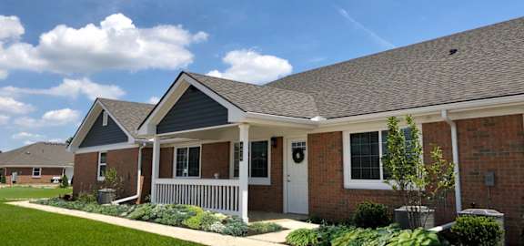 A row of houses with a well-maintained lawn in front.