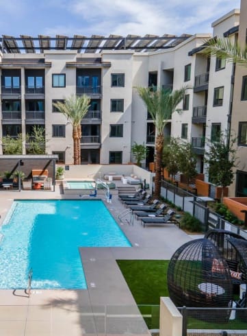 Aura Central Apartments Pool with Lounge Chairs