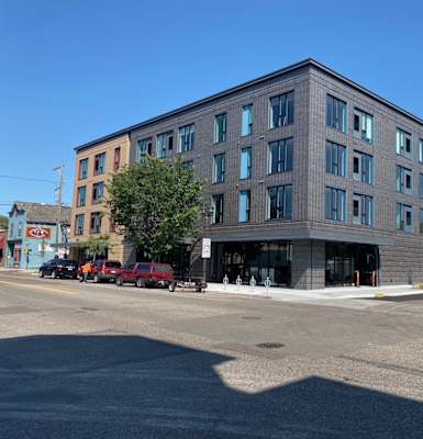 a brick building with a parking lot in front of it