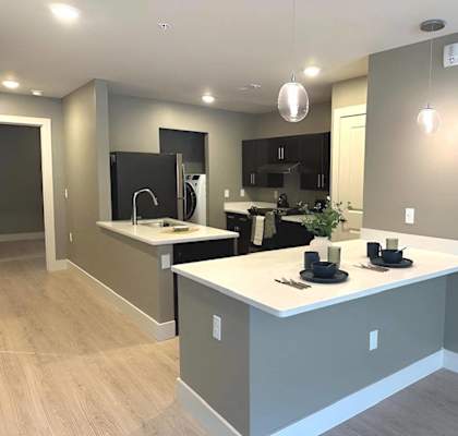 an open kitchen with a large island in the middle