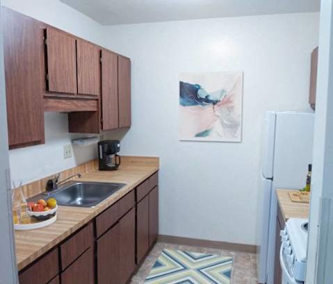 a kitchen with a sink and a refrigerator