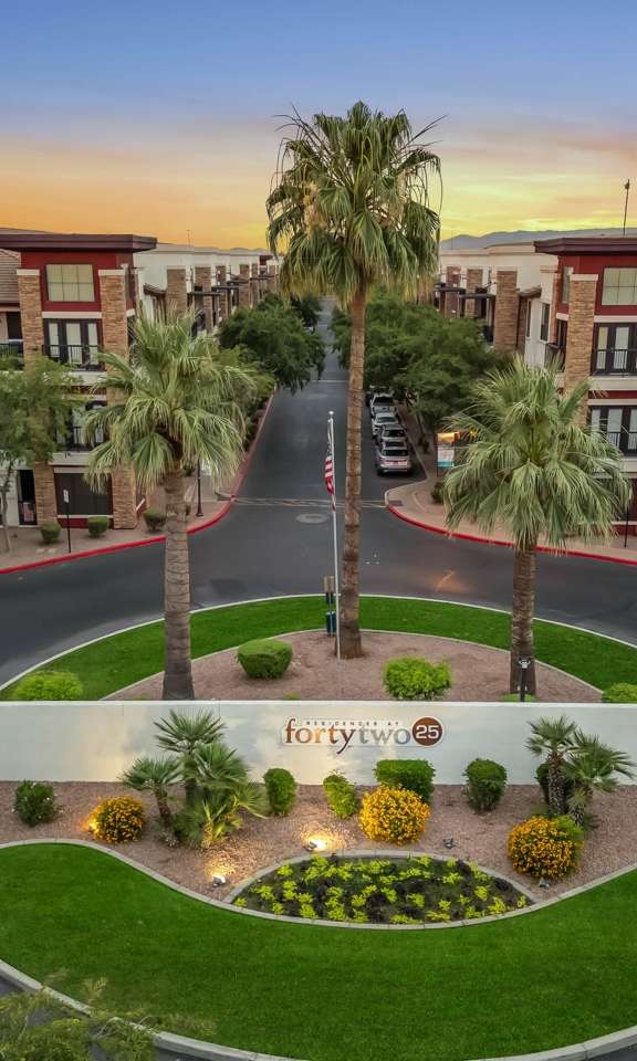 A beautifully landscaped entrance to a Forte 2 apartment complex.