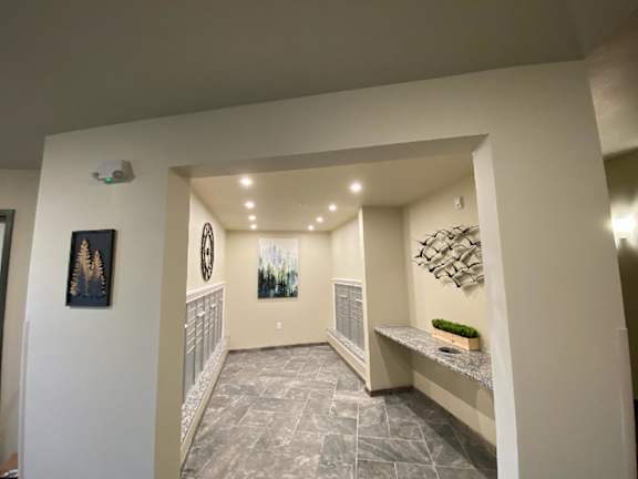 A hallway with a bench and pictures on the wall.