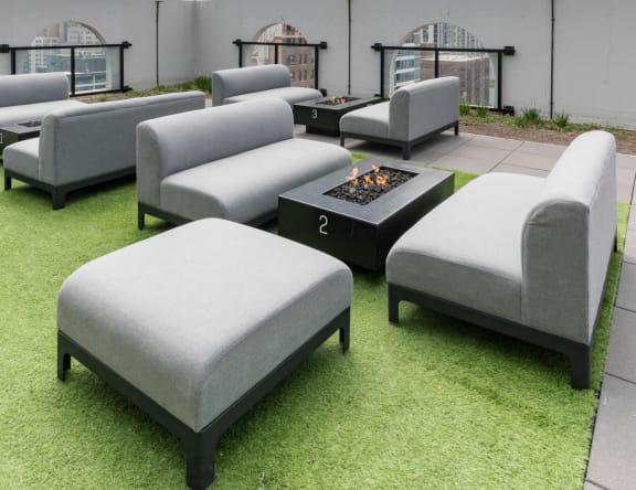 a group of couches and chairs around a fire pit
