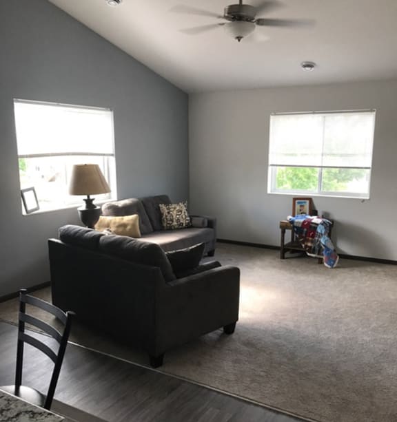 a bedroom with a bed and a ceiling fan