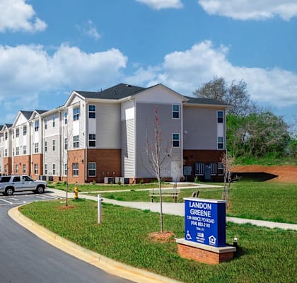 an apartment building with cars parked in front of it