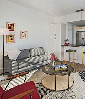 a living room with a couch and a table and chairs
