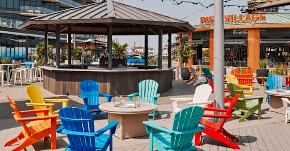 A patio with a gazebo and chairs.