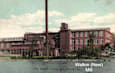 An old red building with the words "Walton (New) Mill" written on it.