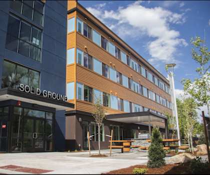 A modern building with the words "SOLID GROUND" on the front.