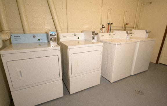 Three white washing machines