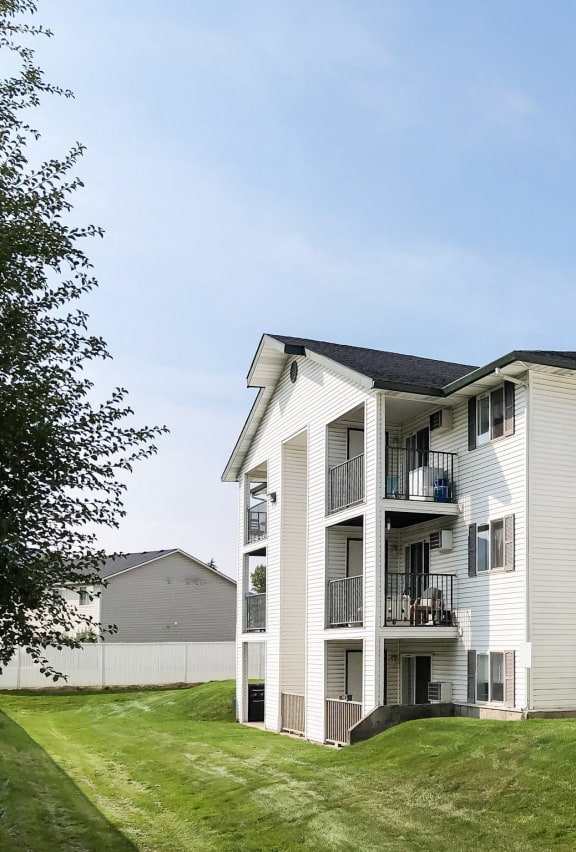 North Pointe Apartments building with green grass and blue skies.