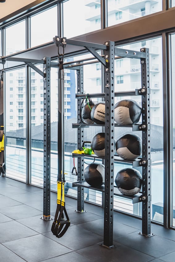 a gym with weights and cardio machines in it