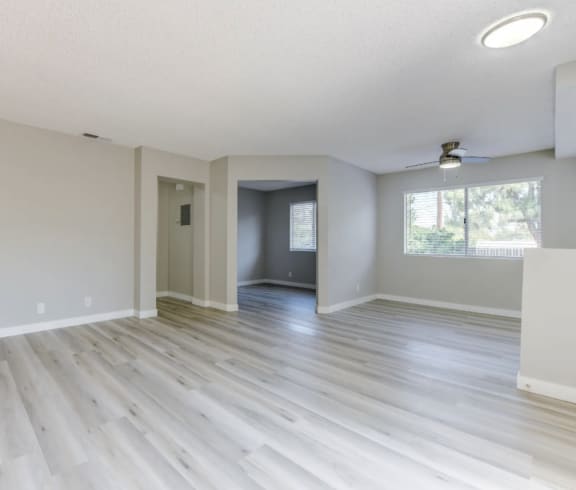 an empty living room with a large window