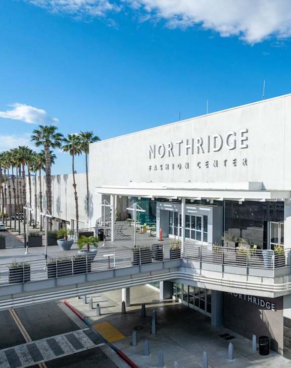 The Northridge Patchouge Centre is a large white building with a balcony.