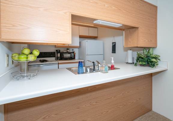 a dining room and kitchen with a table and chairs