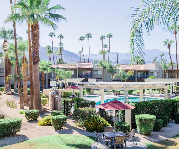 a resort with a pool and palm trees