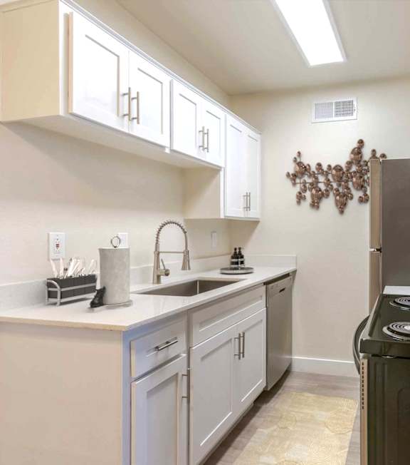 A kitchen with black appliances and a grey countertop at Elevation Apartments, Tucson