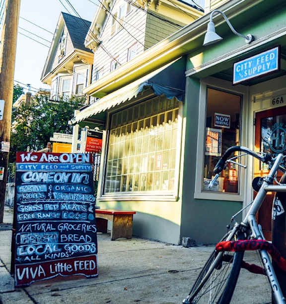 A bike is parked in front of a store with a sign that says "We are open".