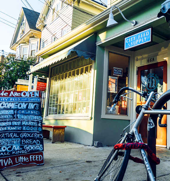 A bike is parked in front of a store with a sign that says "We are open".