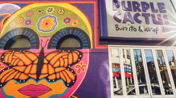 A colorful mural of a butterfly on a building.
