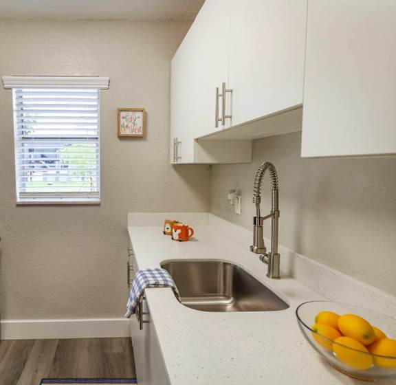 A kitchen with a stove, microwave, and oven.