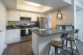 Kitchen with stainless steel appliances and bar seating at Salado Springs, Arizona, 85281