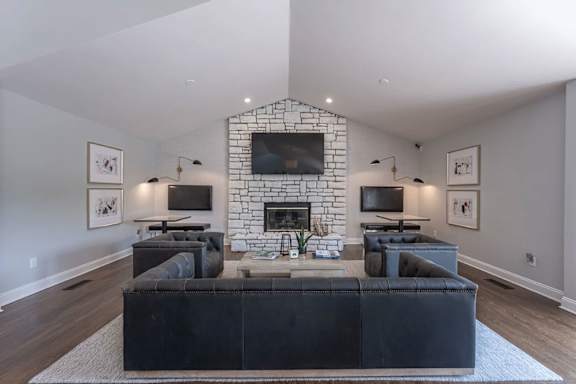 A living room with a fireplace and a large couch.